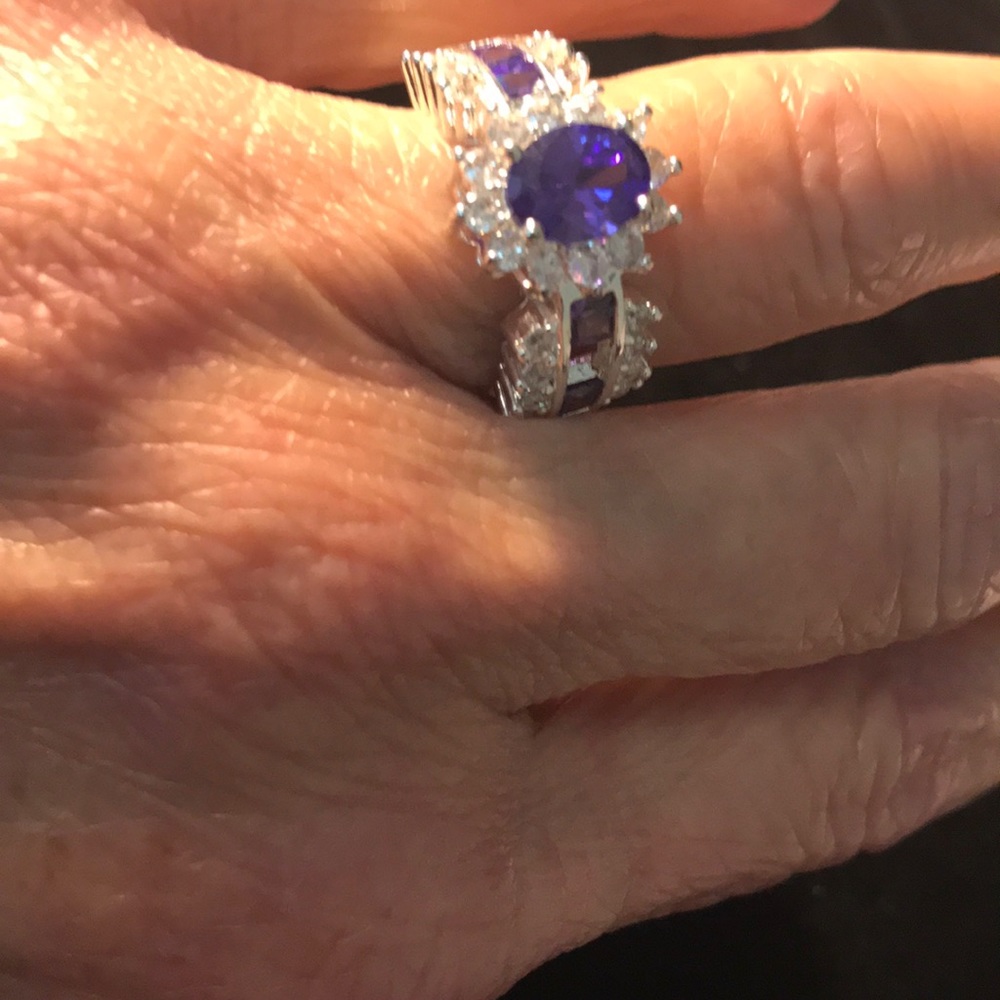 Ladies ring. Purple colored and clear stones.